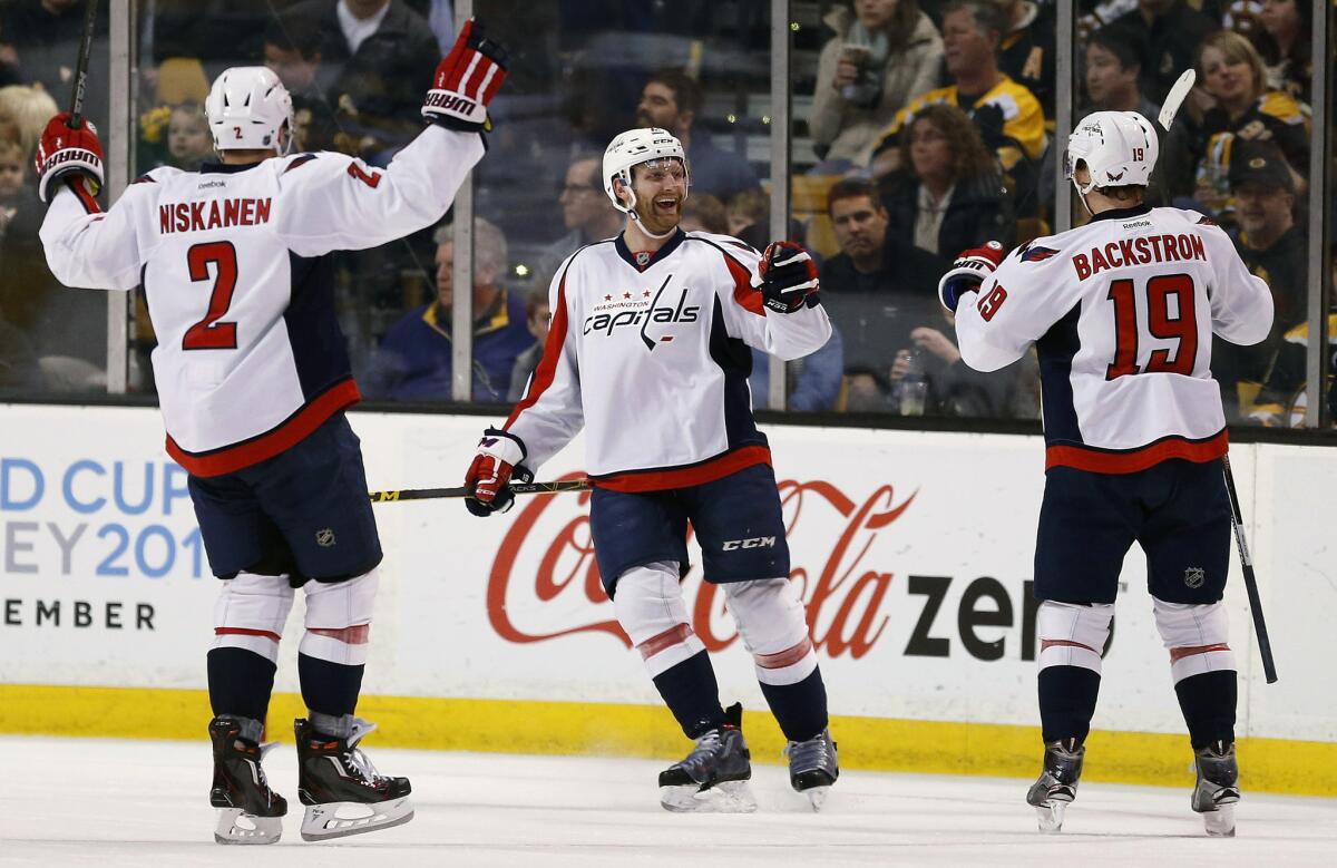 Capitals defenseman Karl Alzner (27) celebrates his goal with teammates Nicklas Backstrom (19) and Matt Niskanen (2) during the second period of a game against the Boston Bruins.