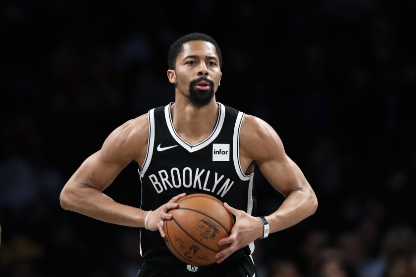 FILE - In this March 4, 2020, file photo, Brooklyn Nets guard Spencer Dinwiddie looks to pass the ball during the team's NBA basketball game against the Memphis Grizzlies in New York. The Washington Wizards have agreed to a $62 million, three-year deal with Dinwiddie, according to a person with knowledge of the agreement. The person, who spoke to The Associated Press on condition of anonymity Wednesday, Aug. 4, because the deal had not been announced, said Dinwiddie is heading to the Wizards in a sign-and-trade. (AP Photo/Kathy Willens, File)