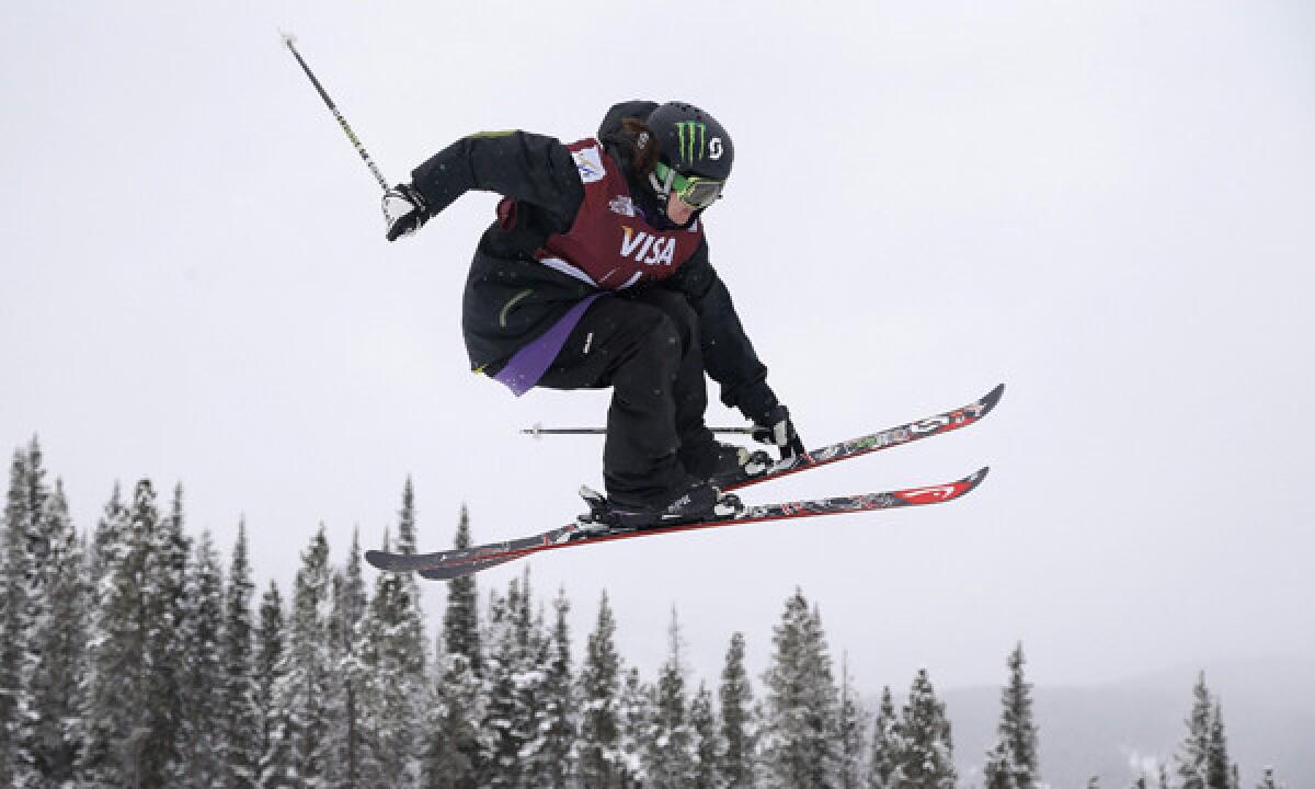 U.S. Olympian Keri Herman grabs a ski while performing a jump during a World Cup slopestyle freestyle skiing event in Colorado on Dec. 21. Herman's passion for the new Olympic sport was preceded by a love for hockey.