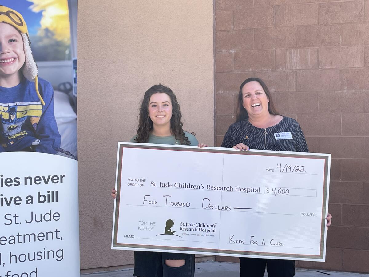 CCA senior Kiara Blacher and Jennifer Castell from St. Jude during a brief handover ceremony.