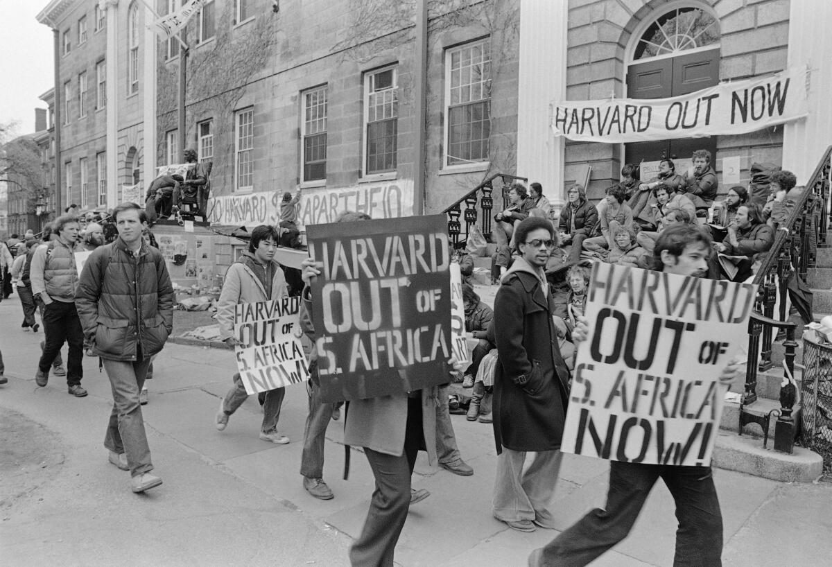 A black-and-white photo of people at an anti-apartheid protest at Harvard in 1978.