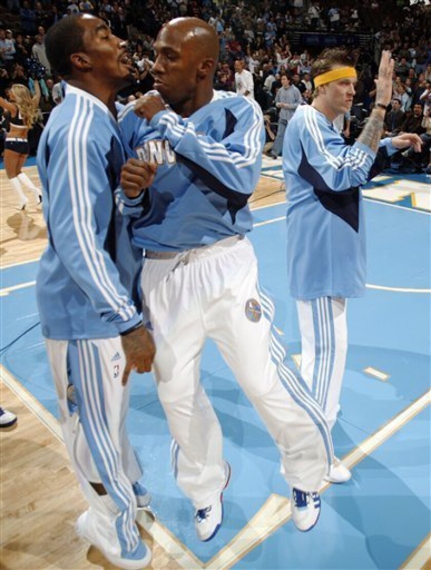 Denver Nuggets guard J.R. Smith, left, welcomes guard Chauncey Billups, center, to the court as he is introduced as a member of the starting lineup to face the Dallas Mavericks in the first quarter of an NBA basketball game in Denver on Friday, Nov. 7, 2008. Nuggets forward Chris Andersen, right, looks on. The game was the first for Billups since he was acquired by the Nuggets in a trade with the Detroit Pistons earlier this week. (AP Photo/David Zalubowski)