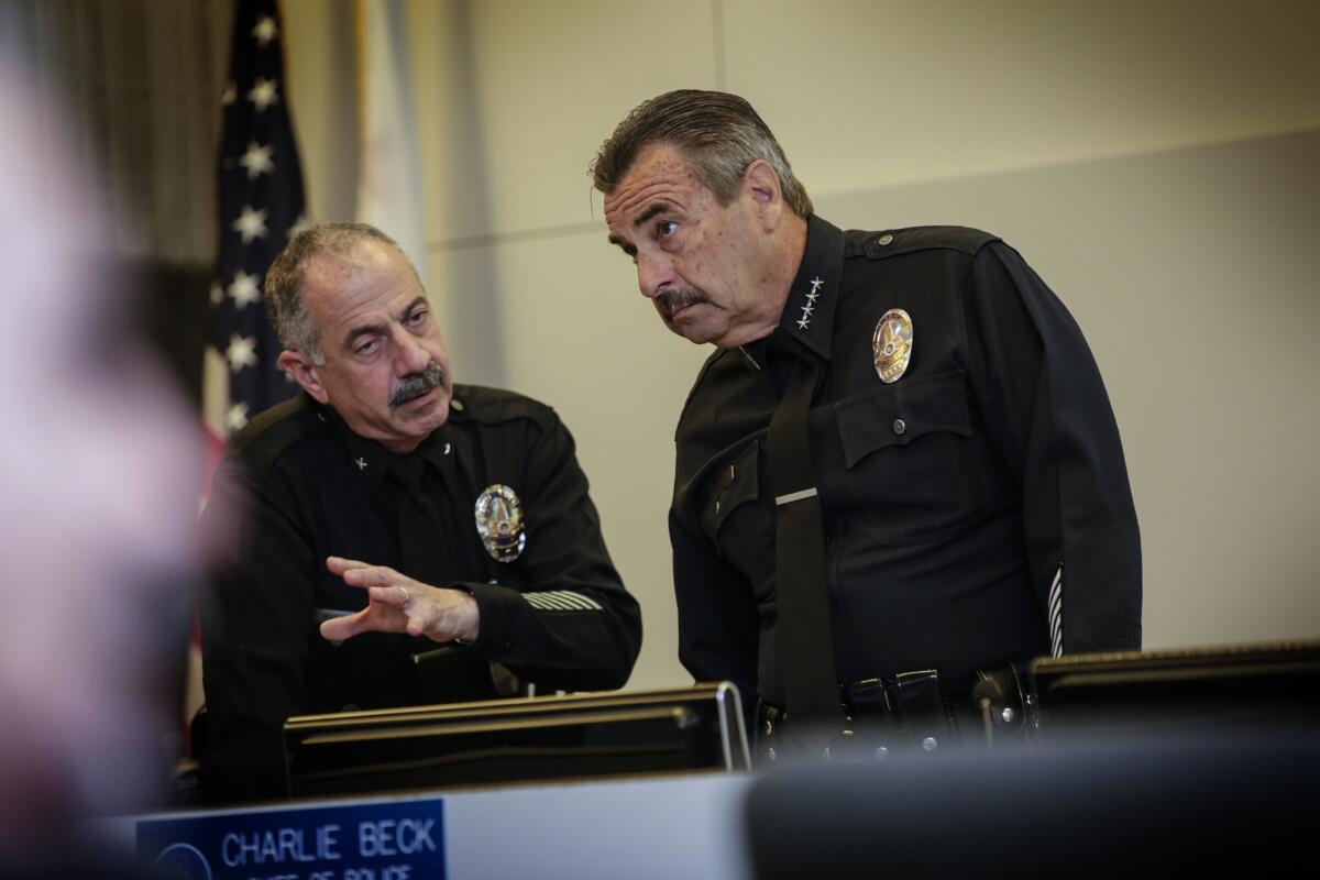 LAPD Cmd. Stuart Maislin of the internal affairs group, left, chats with Chief Charlie Beck before a board of police commissioners meeting on March 1.