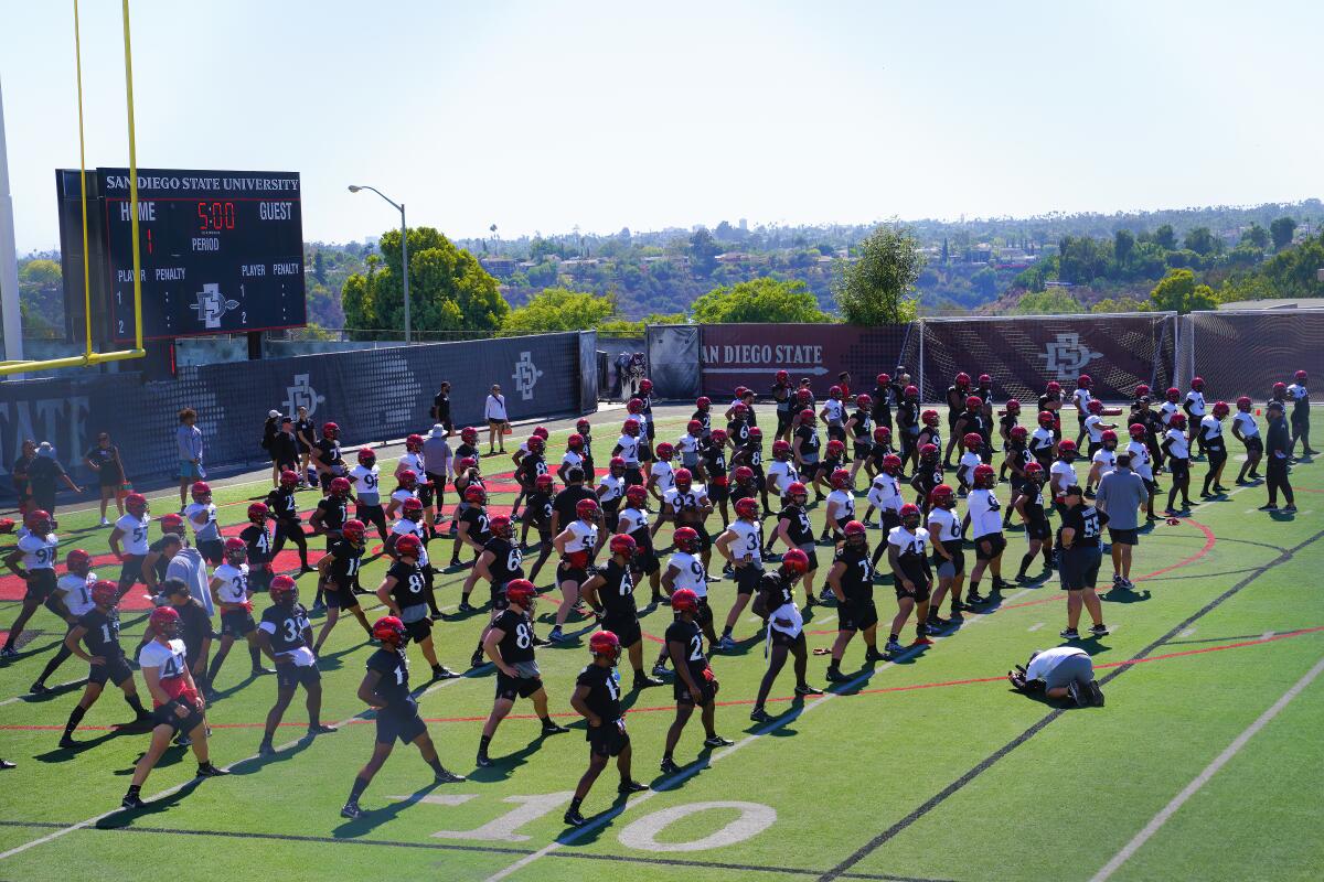 San Diego State football players stretch during Friday's opening practice for the 2022 season.