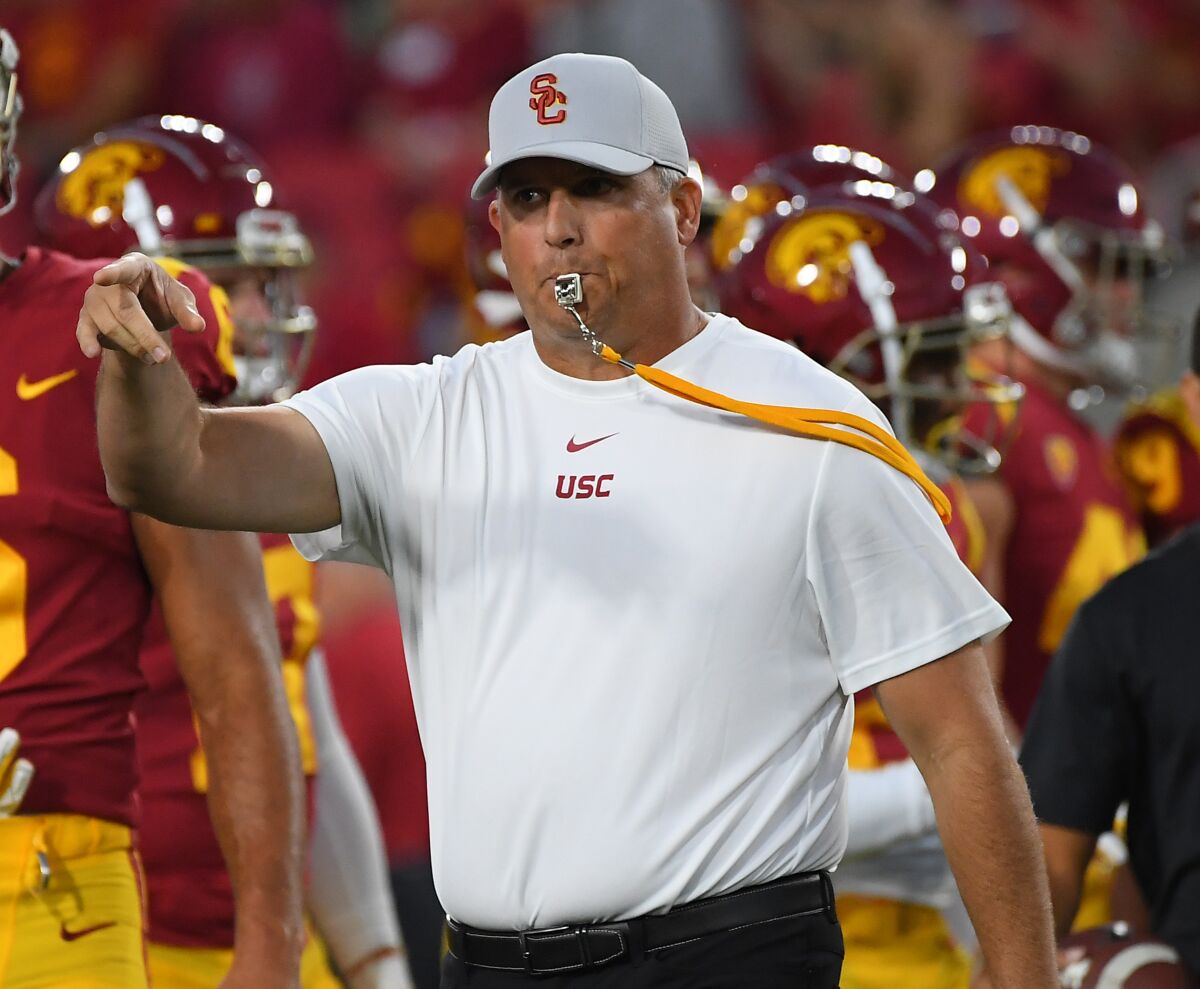 USC coach Clay Helton and the Trojans are beginning a grueling, three-game stretch against ranked teams, starting Friday against No. 10 Utah.