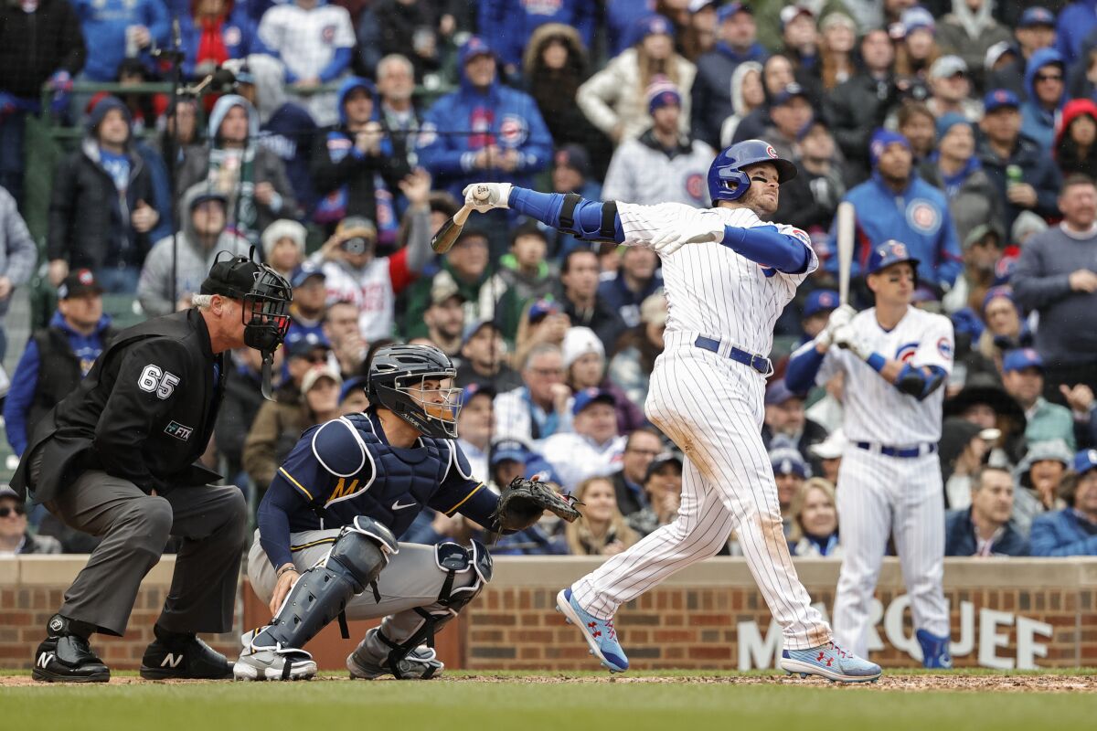 Chicago Cubs' Ian Happ hits a two-run double against the Milwaukee Brewers during the seventh inning of a baseball game, Thursday, April 7, 2022, in Chicago. (AP Photo/Kamil Krzaczynski)