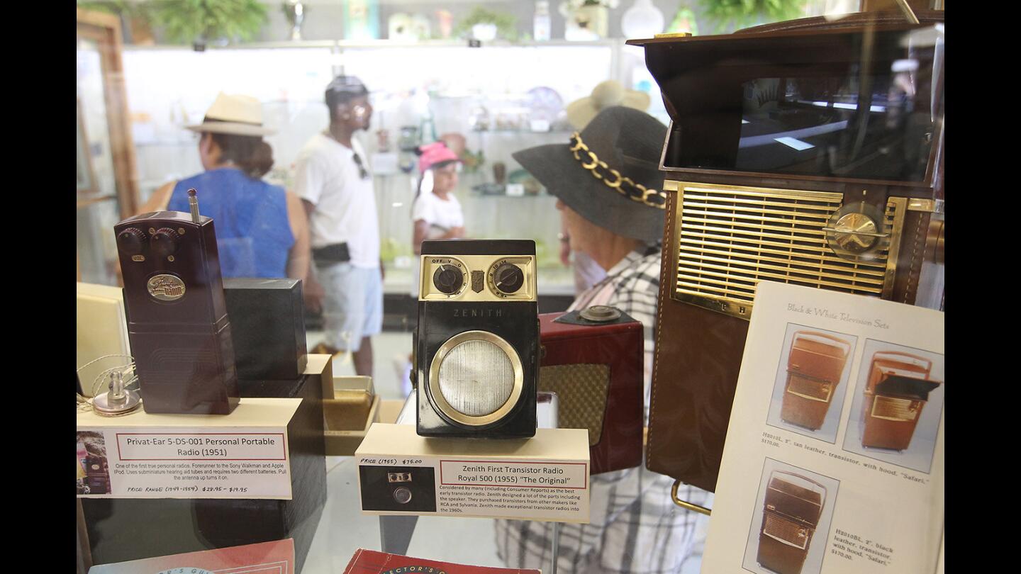 La Palma resident John Eng has saved and restored old radios from the trash to working condition, including his 1955 Zenith Royal 500, middle, on display at the Collections building at the OC Fair.