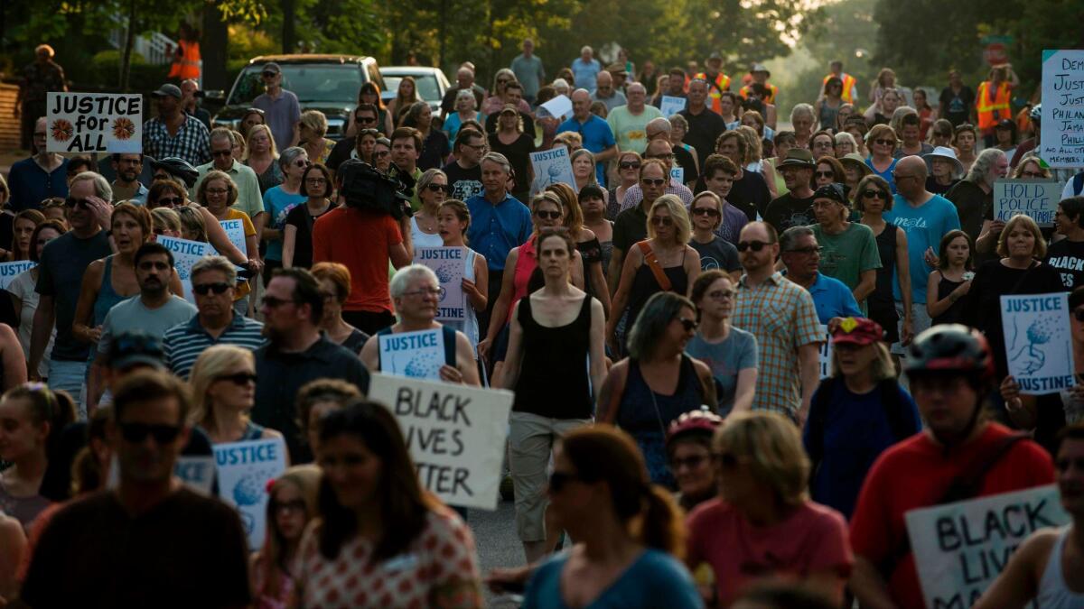 People march on July 20, 2017, in Minneapolis during several days of demonstrations after the death of Justine Damond, who was killed late Saturday by a police officer responding to her emergency call.