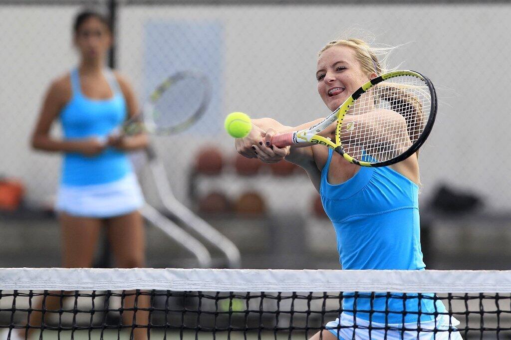 Corona del Mar High's Kenzie Purcifull, right, won twice with teammate Kimmia Naaseh, left, against Newport Harbor in the Battle of the Bay match on Tuesday.