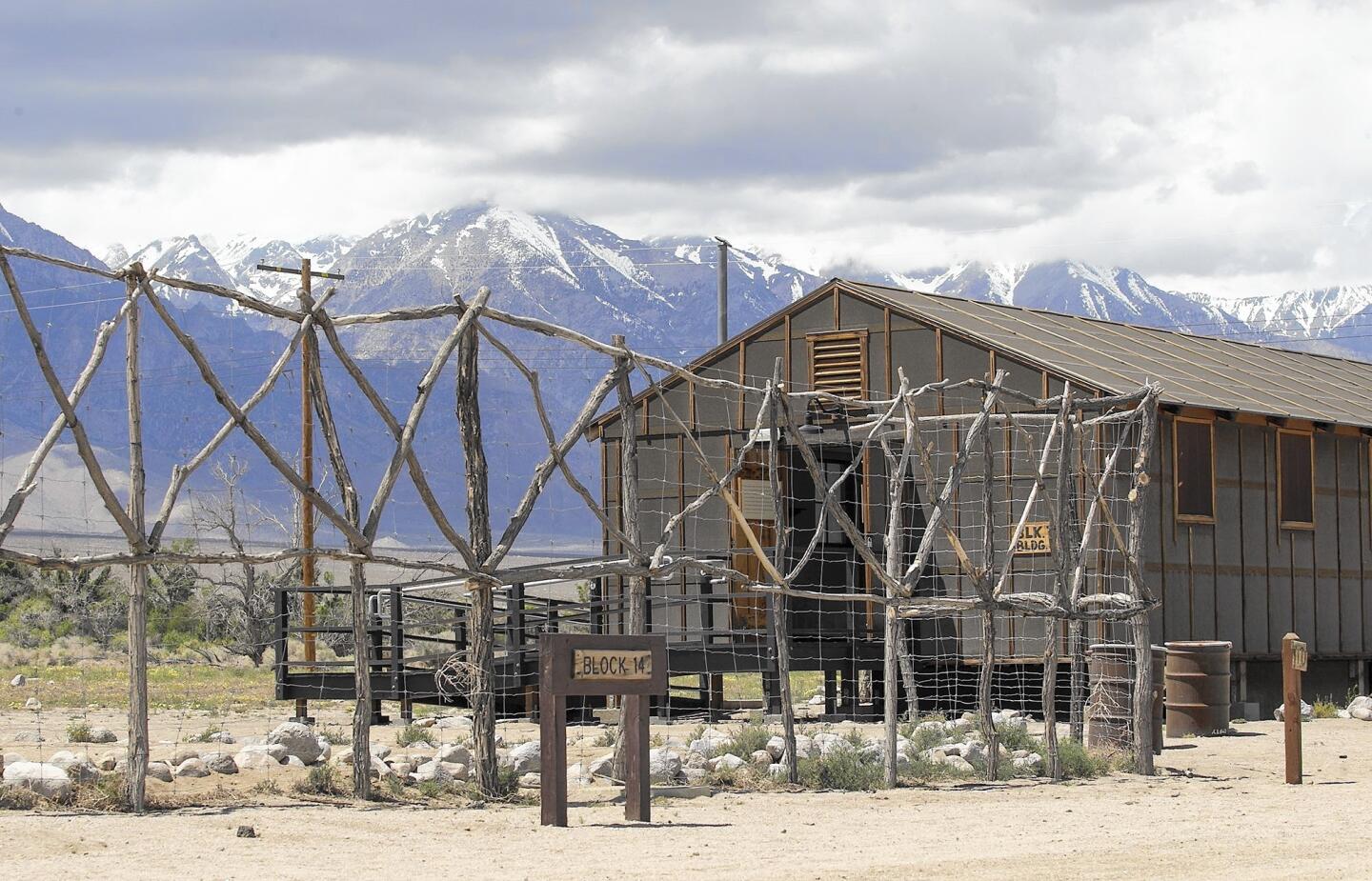 A replica security fence and internment barracks at Manzanar.