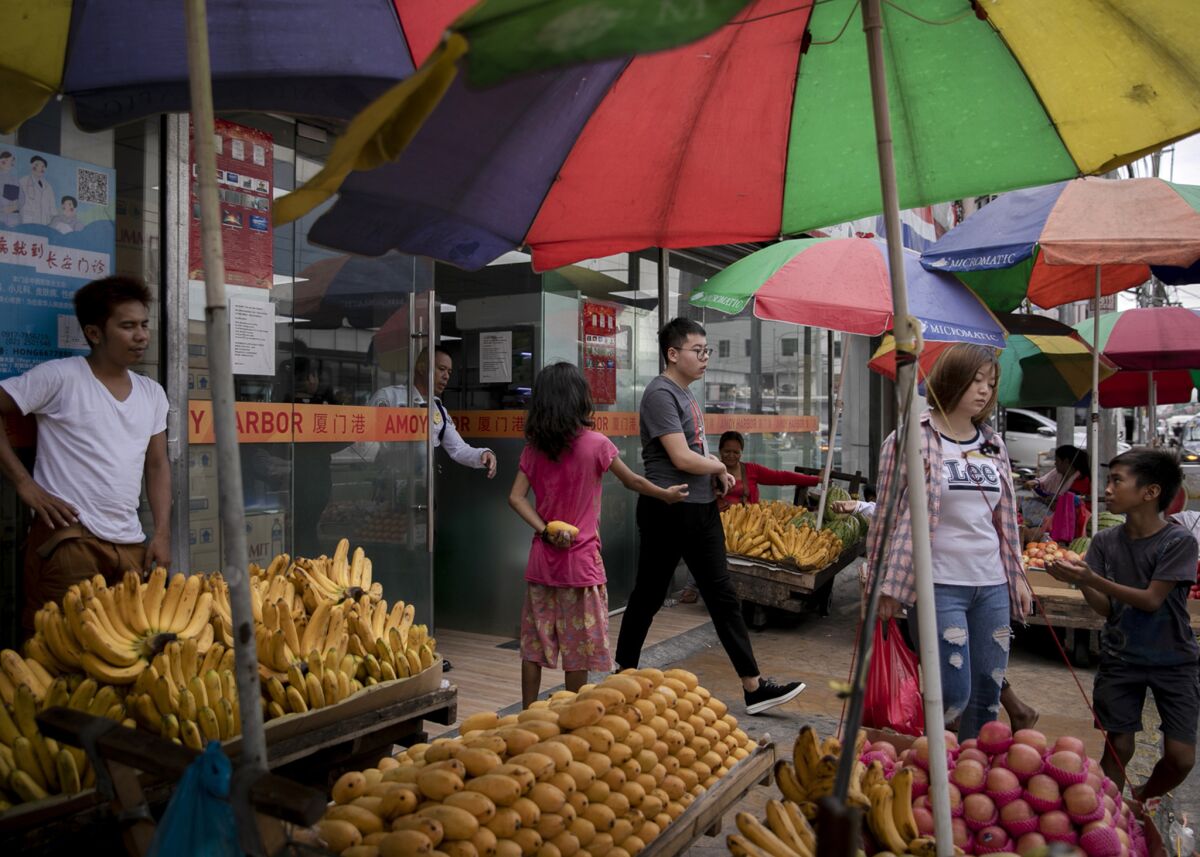Chinese workers at a Chinese grocery store near an office building in Paranaque City, Philippines.