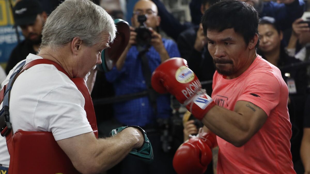 Manny Pacquiao, right, works out with trainer Freddie Roach at a boxing club in Los Angeles on Wednesday, Jan. 9, 2019. Pacquiao is scheduled to defend his WBA welterweight title against Adrien Broner on Jan. 19 in Las Vegas.