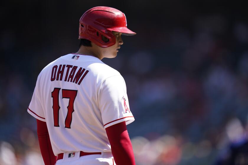 Los Angeles Angels designated hitter Shohei Ohtani (17) stands on third during the first inning of a baseball game against the Texas Rangers in Anaheim, Calif., Sunday, Oct. 2, 2022. (AP Photo/Ashley Landis)