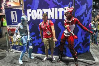 Hayne Palmour IV  U-T Braden Dunlap (center) dances with Fortnite’s Tricera Ops (right) and the Frozen Red Knight during Comic-Con International’s Preview Night.