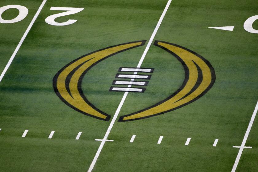 FILE - The College Football Playoff logo is shown on the field at AT&T Stadium before the Rose Bowl NCAA college football game between Notre Dame and Alabama in Arlington, Texas, Jan. 1, 2021. The nine Bowl Subdivision conferences and Notre Dame reached an agreement Friday, March 15, 2024, on a six-year deal to continue the College Football Playoff through the 2031 season, a significant step that establishes a revenue-sharing plan and allows the CFP to finalize a media rights agreement.(AP Photo/Roger Steinman, File)