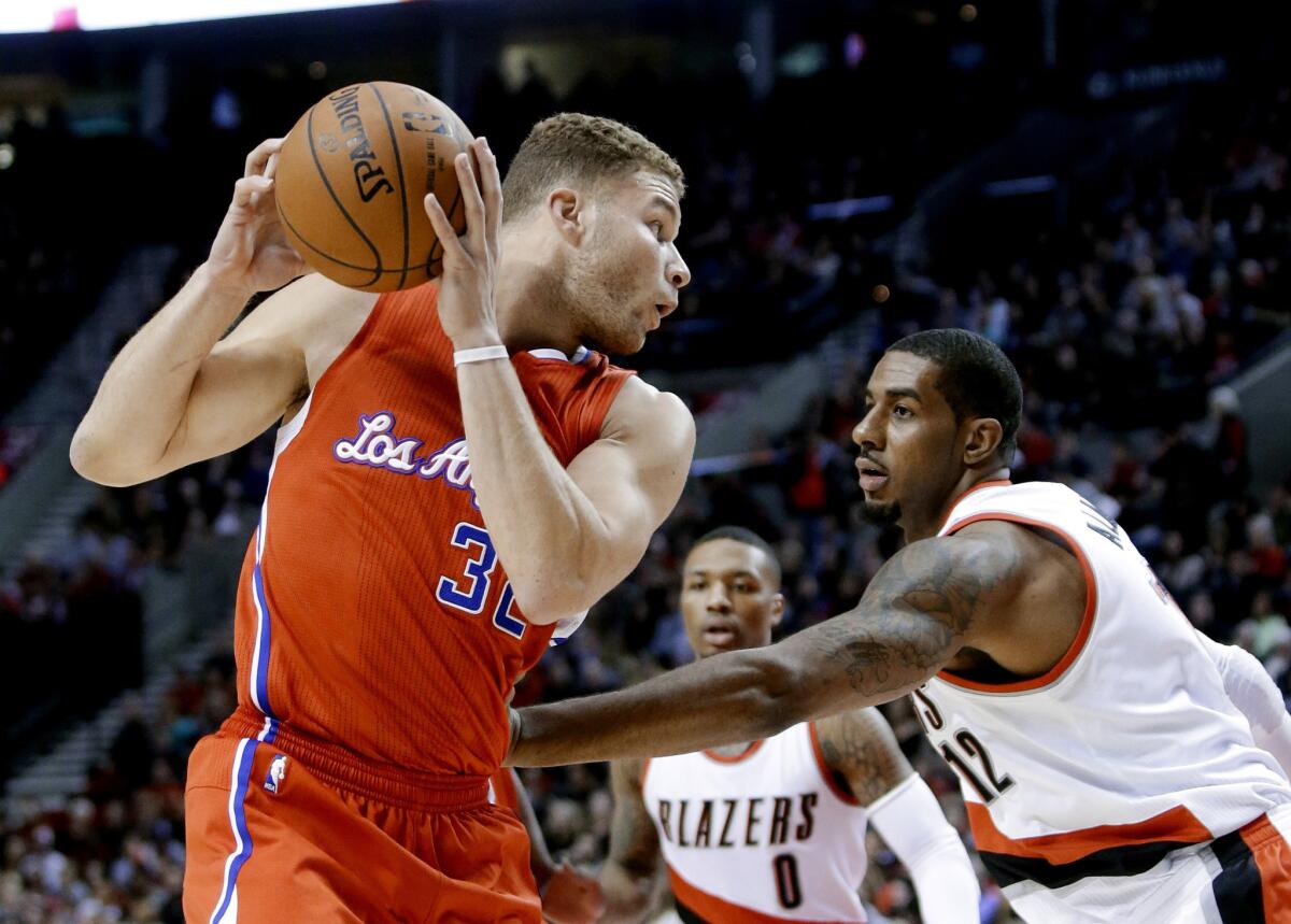Blake Griffin is defended by Portland forward LaMarcus Aldridge during the first half of a game Wednesday at the Moda Center.