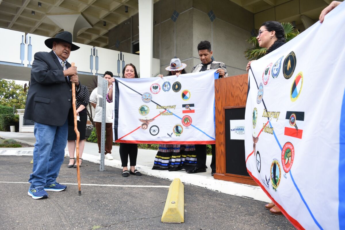 Jamul Indian Village Councilmember Jesse Pinto Sr. offers a blessing of two Kumeyaay flags in National City.