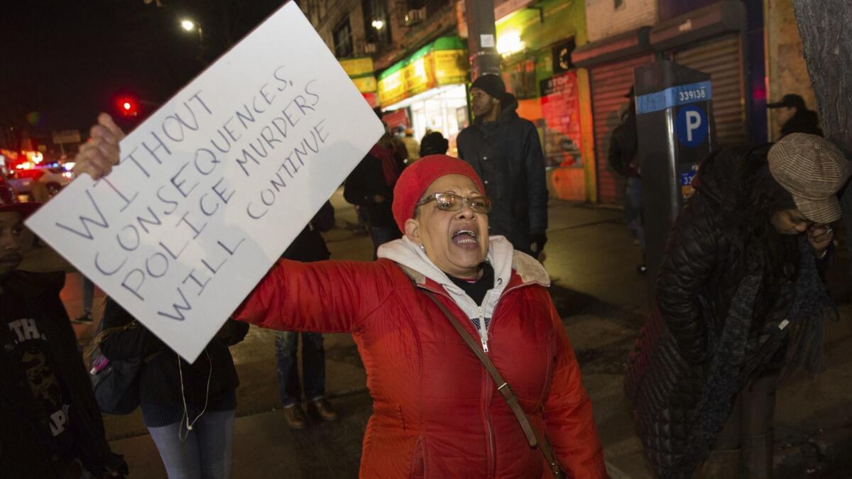People protest after police officers shot and killed a man in Brooklyn, N.Y., on April 4.