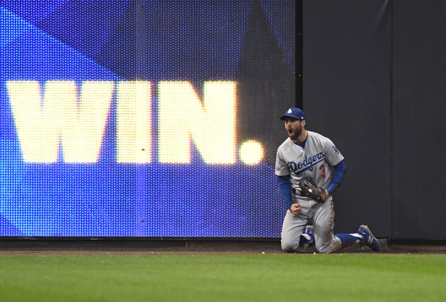 Dodgers left fielder Chris Taylor celebrates after catching a drive by Brewers Christian Yelich in the 5th inning.