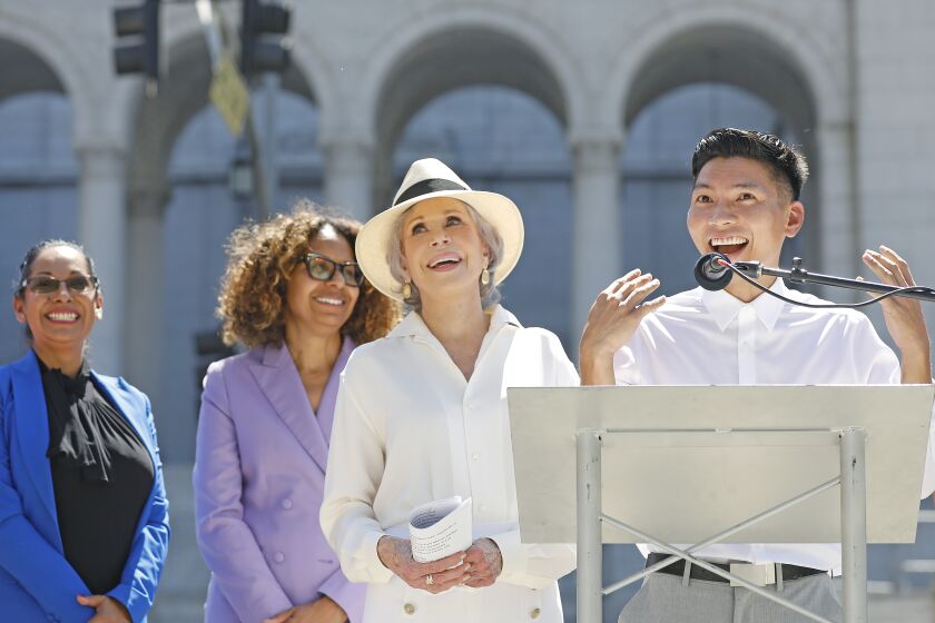LOS ANGELES, CA - SEPTEMBER 1, 2022: Jane Fonda, center, holds a press conference to announce the Jane Fonda Climate PAC's endorsement of a slate of Los Angeles area candidates including Kenneth Mejia, right, who is running for Los Angeles City Controller, at Grand Park in downtown Los Angeles on Thursday, September 1, 2022. (Christina House / Los Angeles Times)