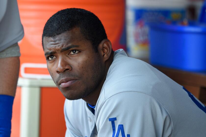 Dodgers' Yasiel Puig looks on from the dugout against Washington on July 21.