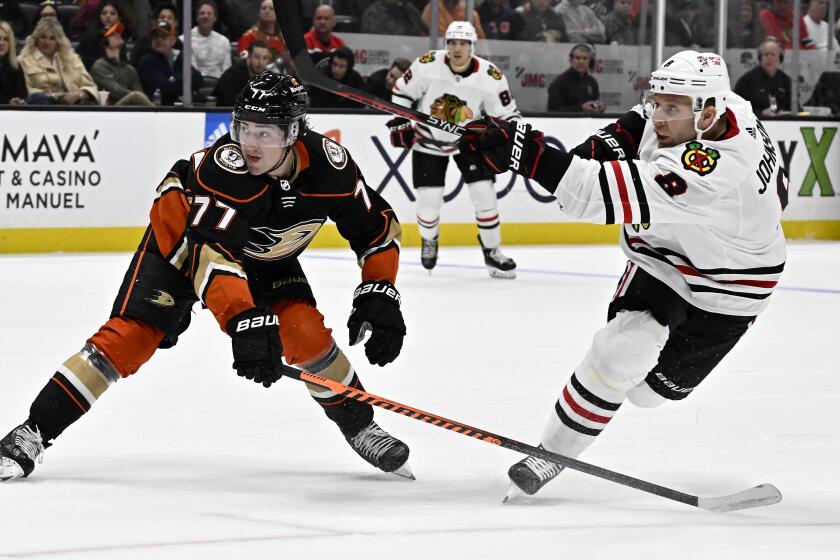 Chicago Blackhawks defenseman Jack Johnson, right, shoots against Anaheim Ducks right wing Frank Vatrano.