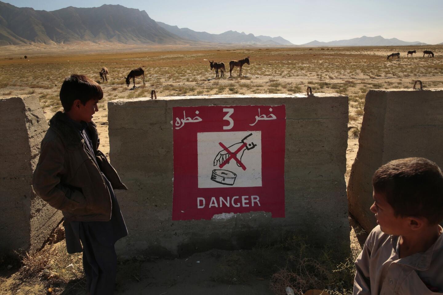 Despite signs warning against it, Afghans, including children, often tend to their animals inside the firing range near Bagram air base. Others scavenge for scrap metal, sometimes picking up unexploded ordnance.