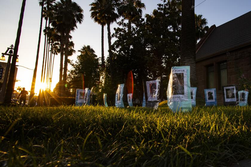 Photographs are set up at the Universalist Unitarian Church in Riverside of Black people killed by police.