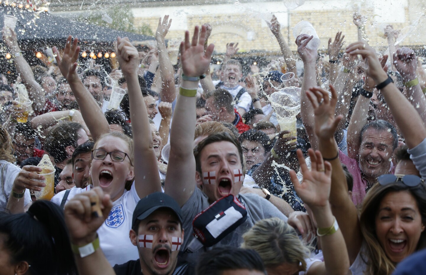 England soccer fans react as they watch a live broadcast on a big screen of the semifinal match between Croatia and England at the 2018 soccer World Cup, in Flat Iron Square, south London, Wednesday, July 11, 2018.