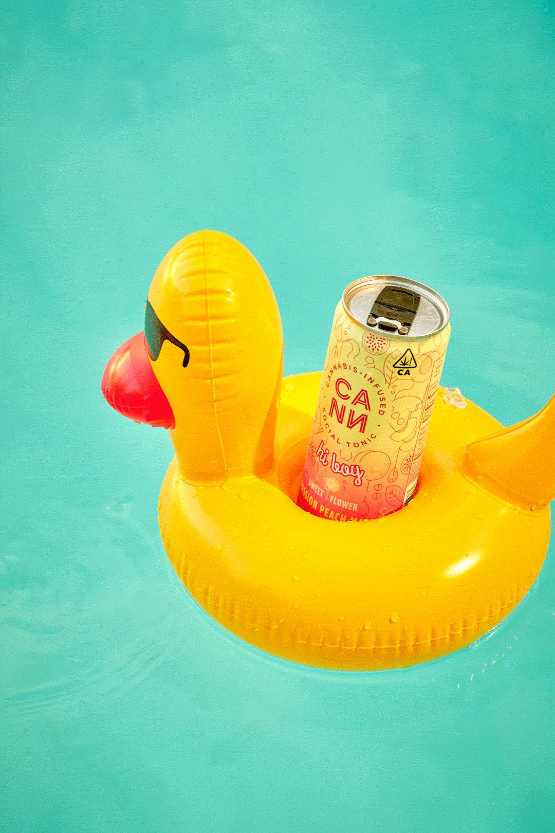 A yellow beverage can in a duck-shaped pool float.