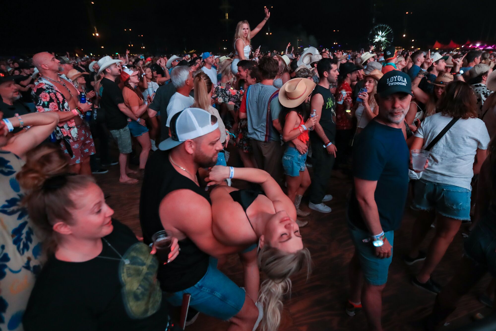 Fans dance in the crowd as Old Dominion performs on the Mane Stage.