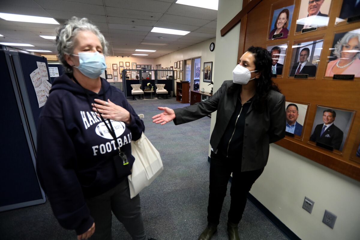 Unhoused senior Linda Fett, left, shares her story with Judith Alonso at the Union Rescue Mission in Skid Row. 