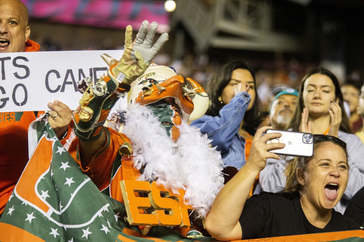 Miami fans celebrate a touchdown against Florida State in the second half of an NCAA college football game in Tallahassee, Fla., Saturday, Nov. 13, 2021. Florida State defeated Miami 32-28. (AP Photo/Mark Wallheiser)