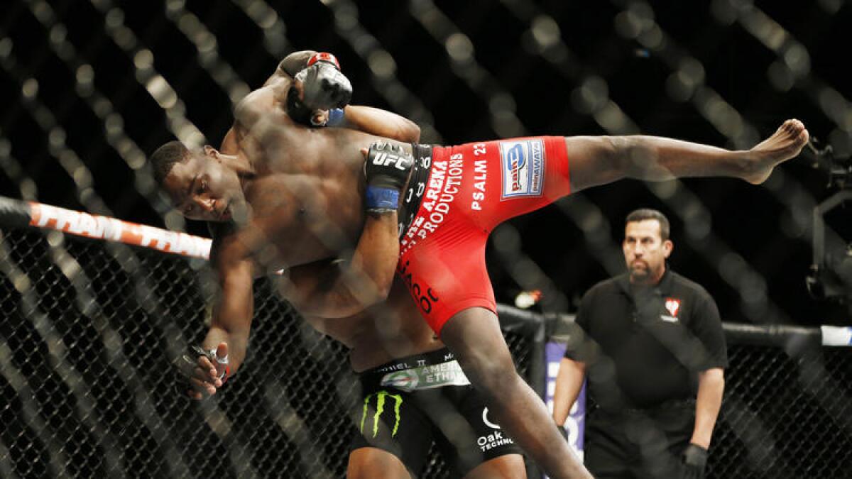 Daniel Cormier tries to take down Anthony Johnson during their light-heavyweight bout on May 23, 2015, in Las Vegas.
