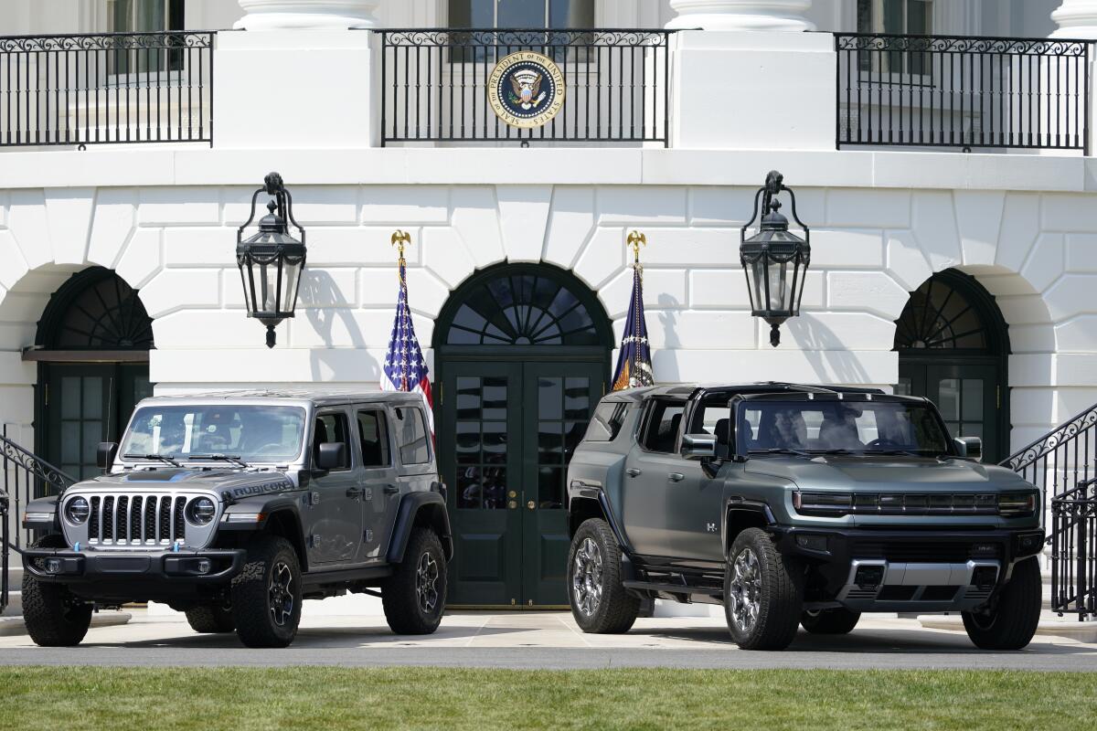 Two electric vehicles are parked on the South Lawn of the White House