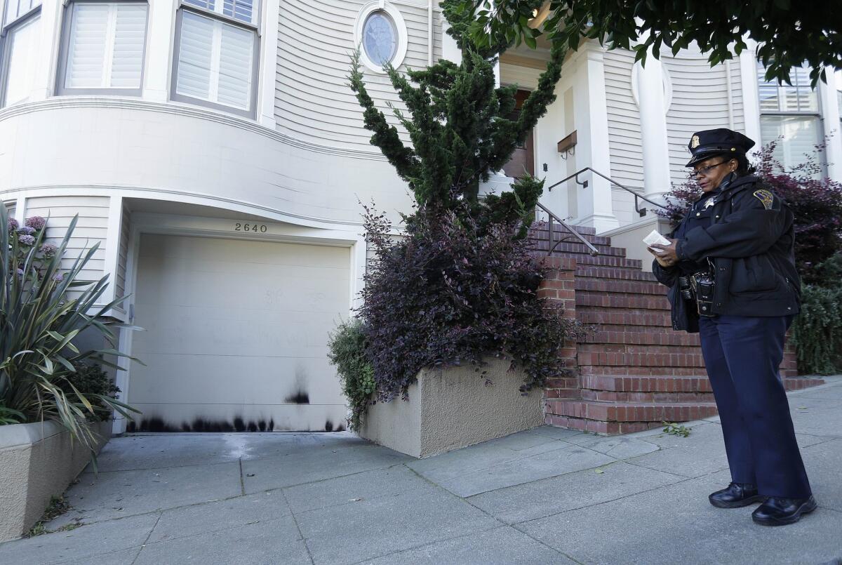 A San Francisco police officer stands outside of a home where the Robin Williams movie "Mrs. Doubtfire" was filmed in San Francisco. Police are investigating two small fires at the home.