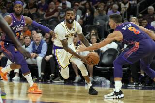 Los Angeles Lakers guard D'Angelo Russell (1) drives between Phoenix Suns forward Josh Okogie (2) and guard Grayson Allen (8) during the first half of an NBA basketball game, Sunday, Feb. 25, 2024, in Phoenix. (AP Photo/Rick Scuteri)