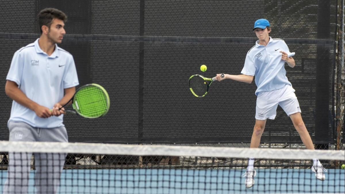 Corona del Mar High's Tyler Hollander returns a shot as his partner Luke Muradliyan waits during the second round of the CIF Southern Section Division 1 playoffs on Friday.