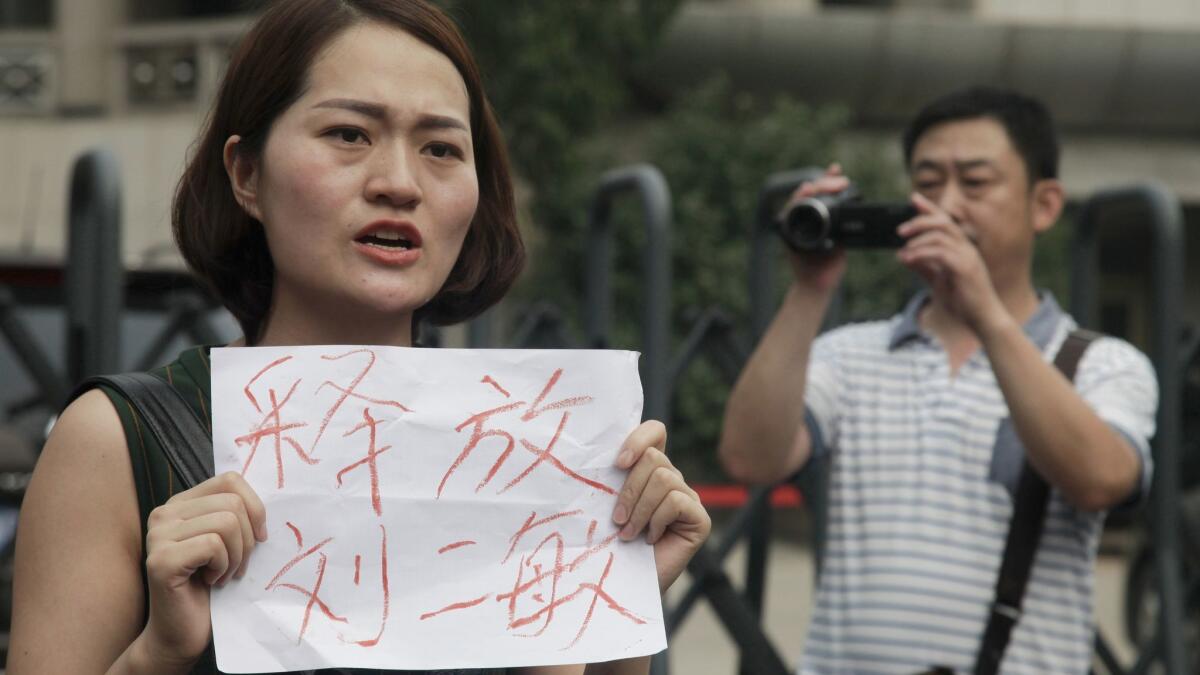 Li Wenzu, left, wife of imprisoned lawyer Wang Quanzhang, joins supporters of a prominent Chinese human rights lawyer and activists as they protest in Tianjin, China, in 2016.