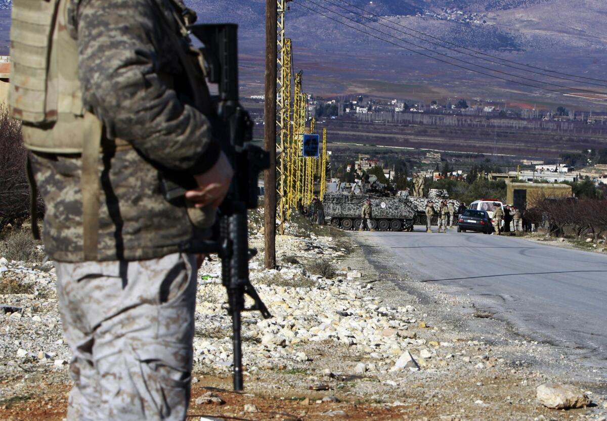 Lebanese army soldiers search civilians at a checkpoint at the entrance of Arsal, a Sunni Muslim town in eastern Lebanon near the Syrian border.