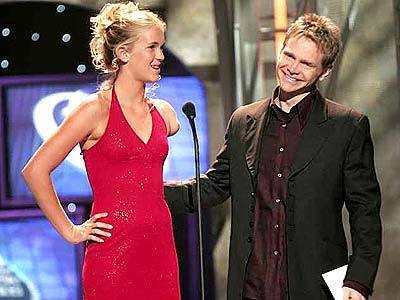 Bethany Hamilton, with Steven Curtis Chapman, keeps her faith center stage at the 35th Annual Gospel Music Awards in April.