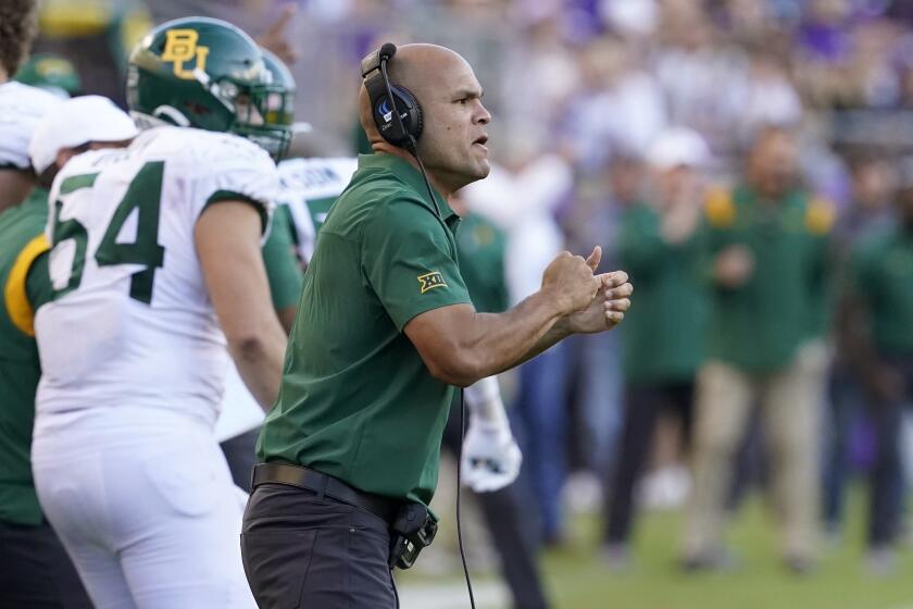 Baylor head coach Dave Aranda, right, celebrates a defensive stop during an NCAA college football game.