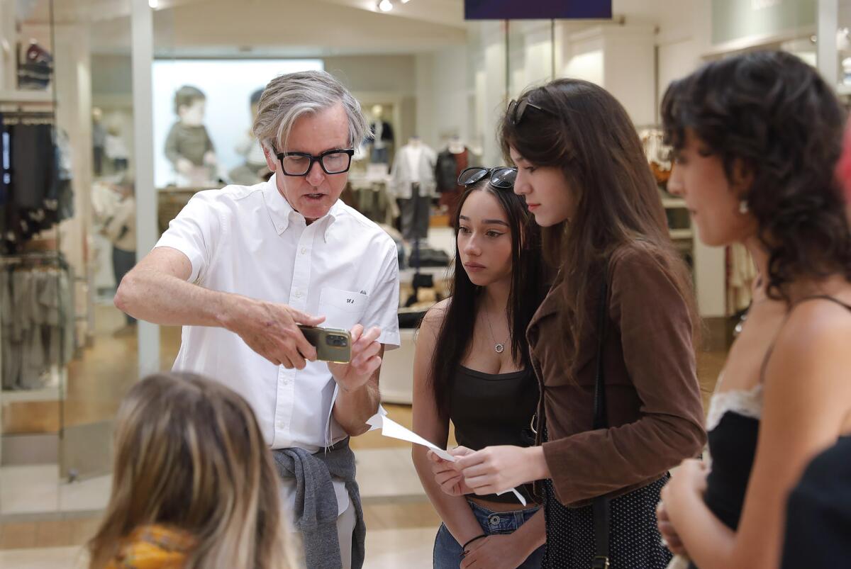 OCC instructor Steve Jones, left, with students in his Display and Visual Presentation class at South Coast Plaza Wednesday.