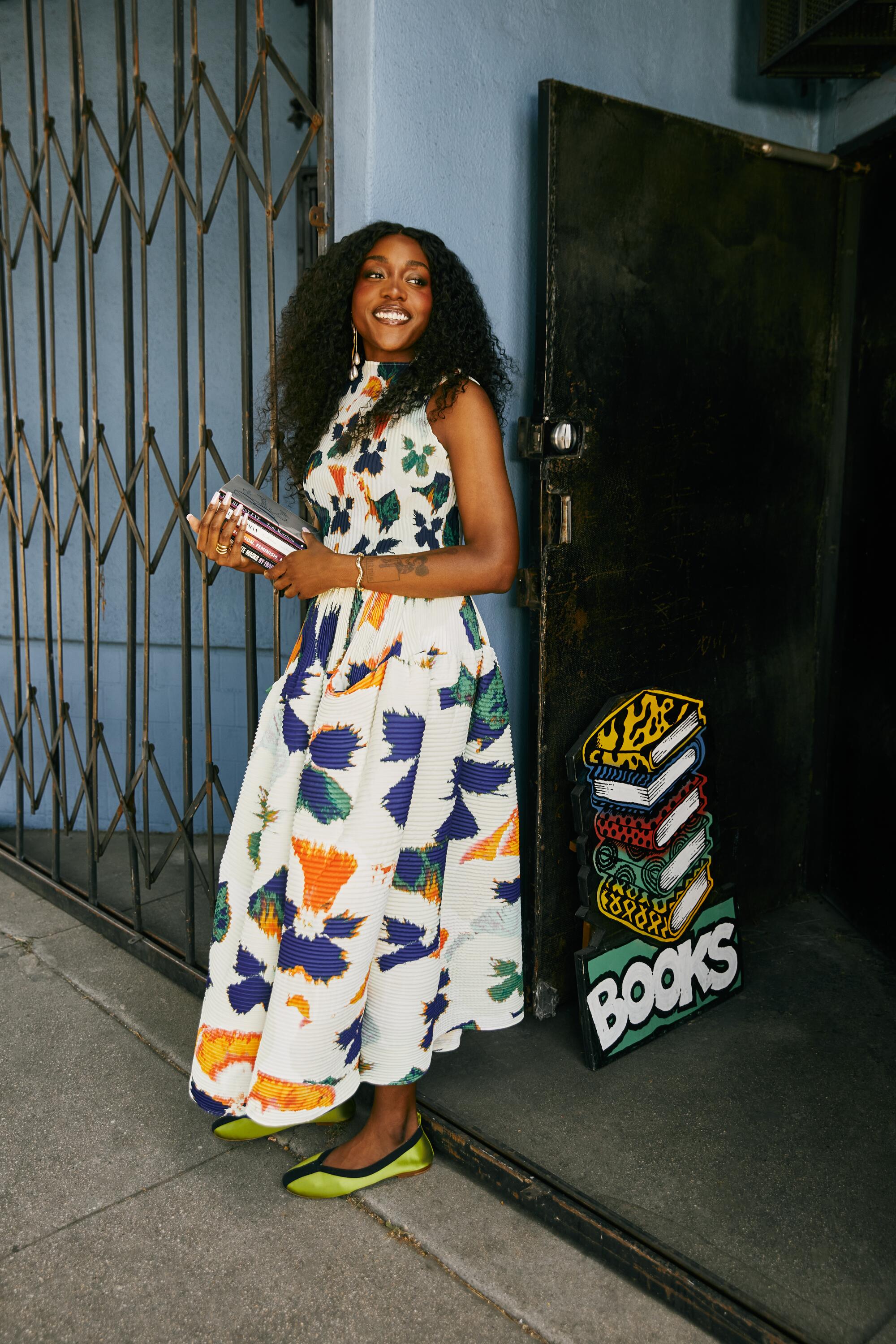 Noname wears Julia Heuer top and skirt, Tory Burch shoes, Laura Estrada earrings, Jenny Bird ring and bracelet.