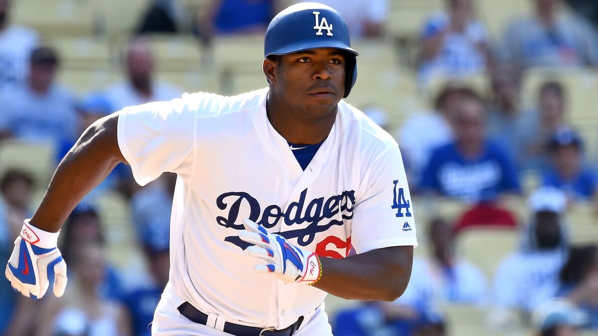 Dodgers right fielder Yasiel Puig breaks out of the batter's box after hitting a double against the Diamondbacks in the eighth inning Sunday.