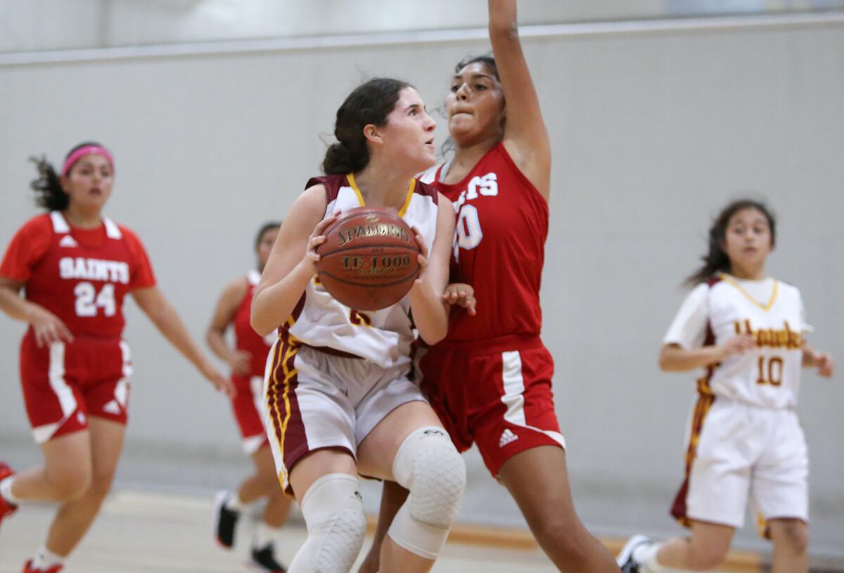 Ocean View's Bella Caiazzo drives to the basket against Santa Ana's Melina Rueda in a Hawk Holiday Classic game on Tuesday in Huntington Beach.