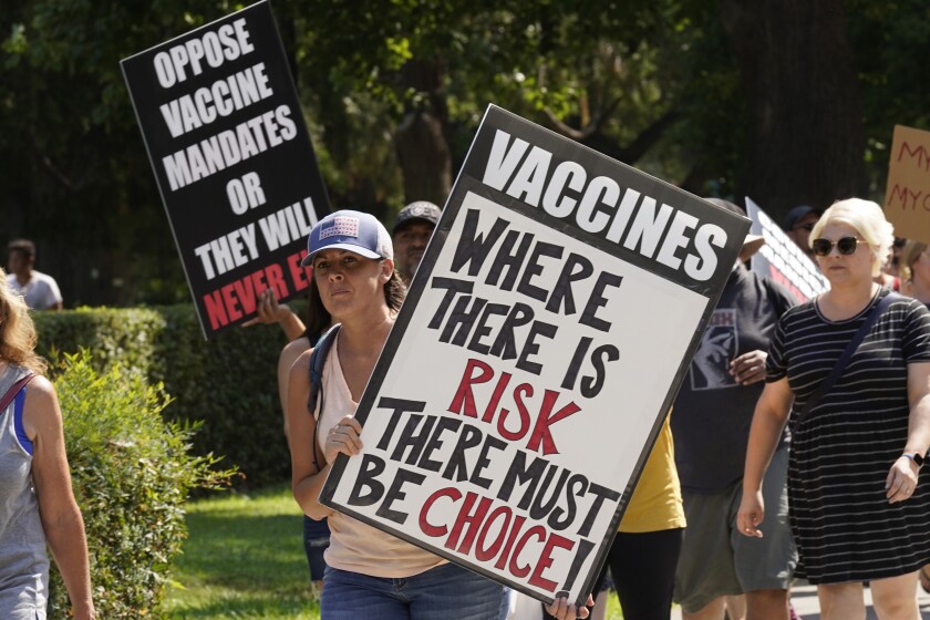 Protesters opposing vaccine mandates march past the Capitol in Sacramento, Calif., Wednesday, Sept. 8, 2021. 