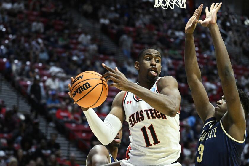 Texas Tech forward Bryson Williams (11) tries to pass around Montana State forward Great Osobor, right, during the second half of a first-round NCAA college basketball tournament game, Friday, March 18, 2022, in San Diego. (AP Photo/Denis Poroy)