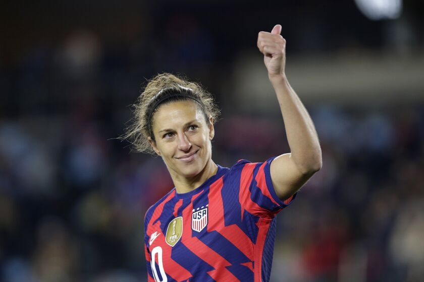 FILE - United States' forward Carli Lloyd salutes fans after a soccer friendly match against South Korea, Tuesday, Oct. 26, 2021, in St. Paul, Minn. JP Dellacamera will be Fox’s lead play-by-play commentator for the third straight Women’s World Cup and two-time FIFA Player of the Year Carli Lloyd will work as a studio analyst, Fox said Thursday, June 8, 2023. (AP Photo/Andy Clayton-King, File)