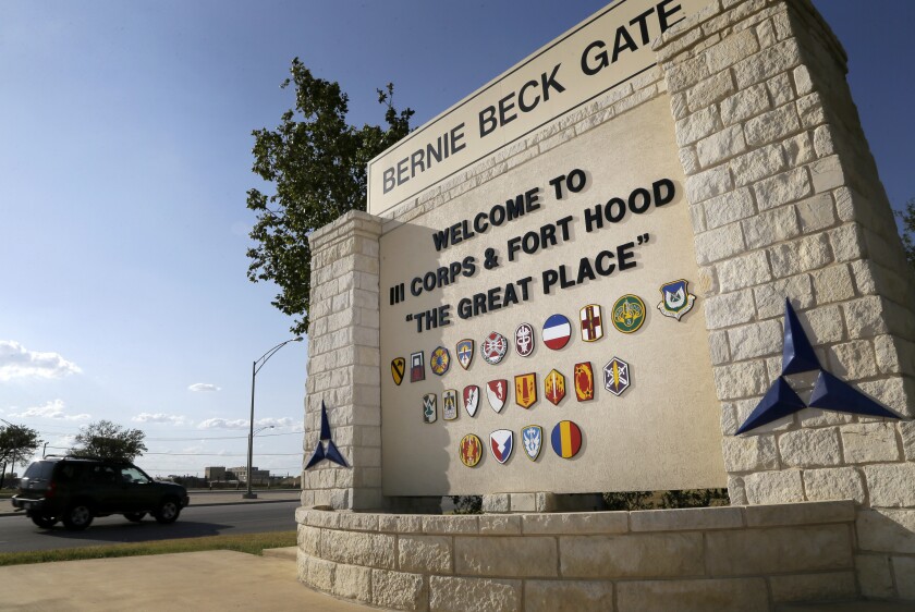 FILE - In this July 9, 2013, file photo, traffic flows through the main gate past a welcome sign in Fort Hood, Texas. U.S. officials say the Army plans to put a civilian in charge of the command that conducts criminal investigations, in response to widespread criticism that the unit is understaffed, overwhelmed and filled with inexperienced investigators.(AP Photo/Tony Gutierrez, File)
